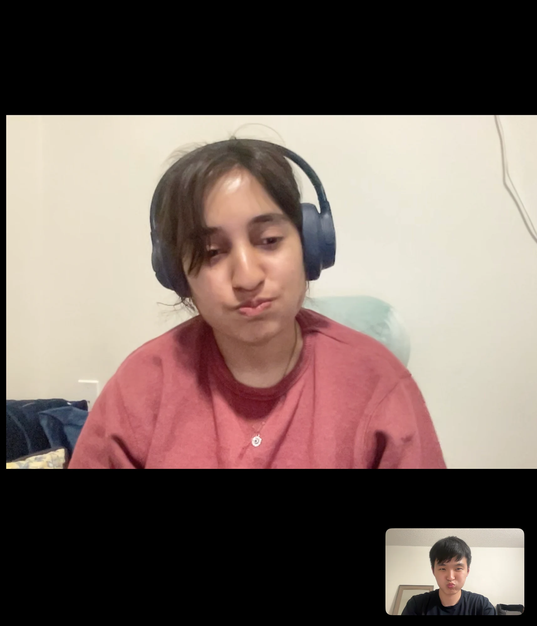video call headphones and pink sweater